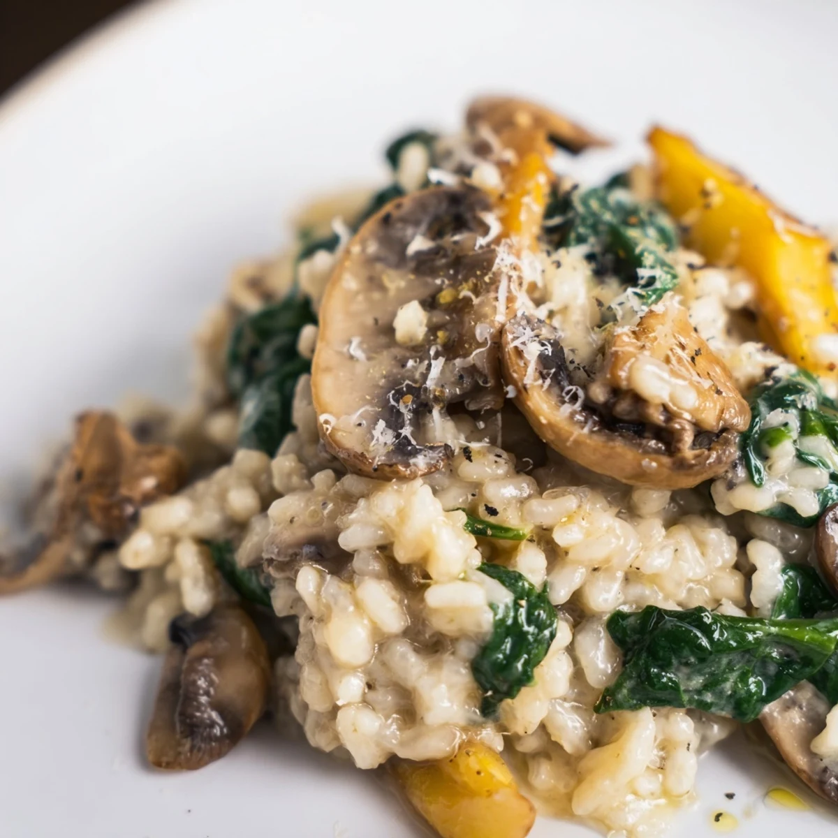 Lusciously creamy Mushroom and Spinach Risotto garnished with fresh herbs, delightful comfort food.  