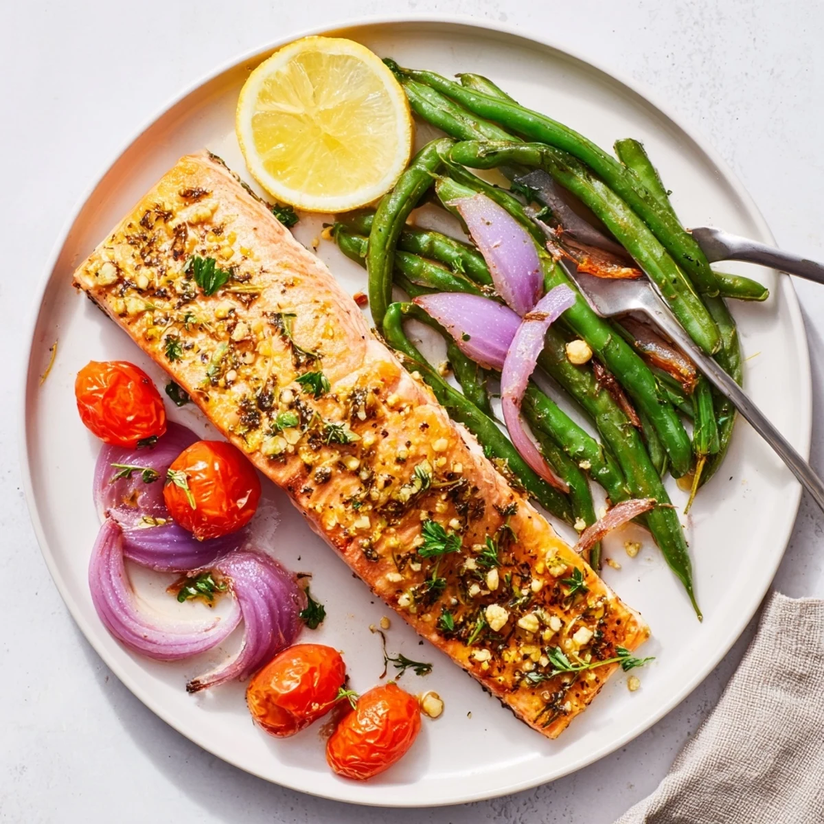 Flavorful Easy One-Pan Lemon Garlic Salmon served with roasted cherry tomatoes and green beans.