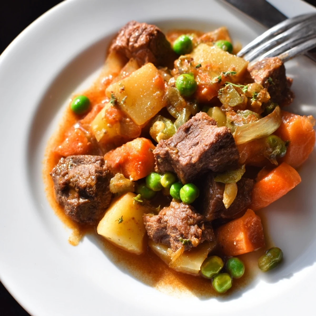 A steaming bowl of Hearty Beef and Vegetable Casserole, rich in flavors and textures, ready to enjoy.  
