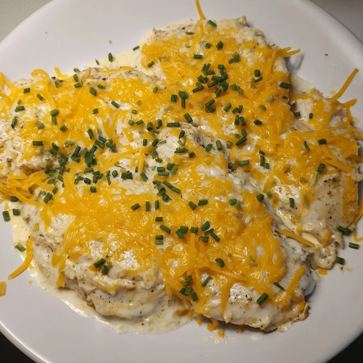 Juicy baked chicken breasts smothered in creamy ranch and cheddar cheese, a delicious Cheddar Ranch Chicken Bake.