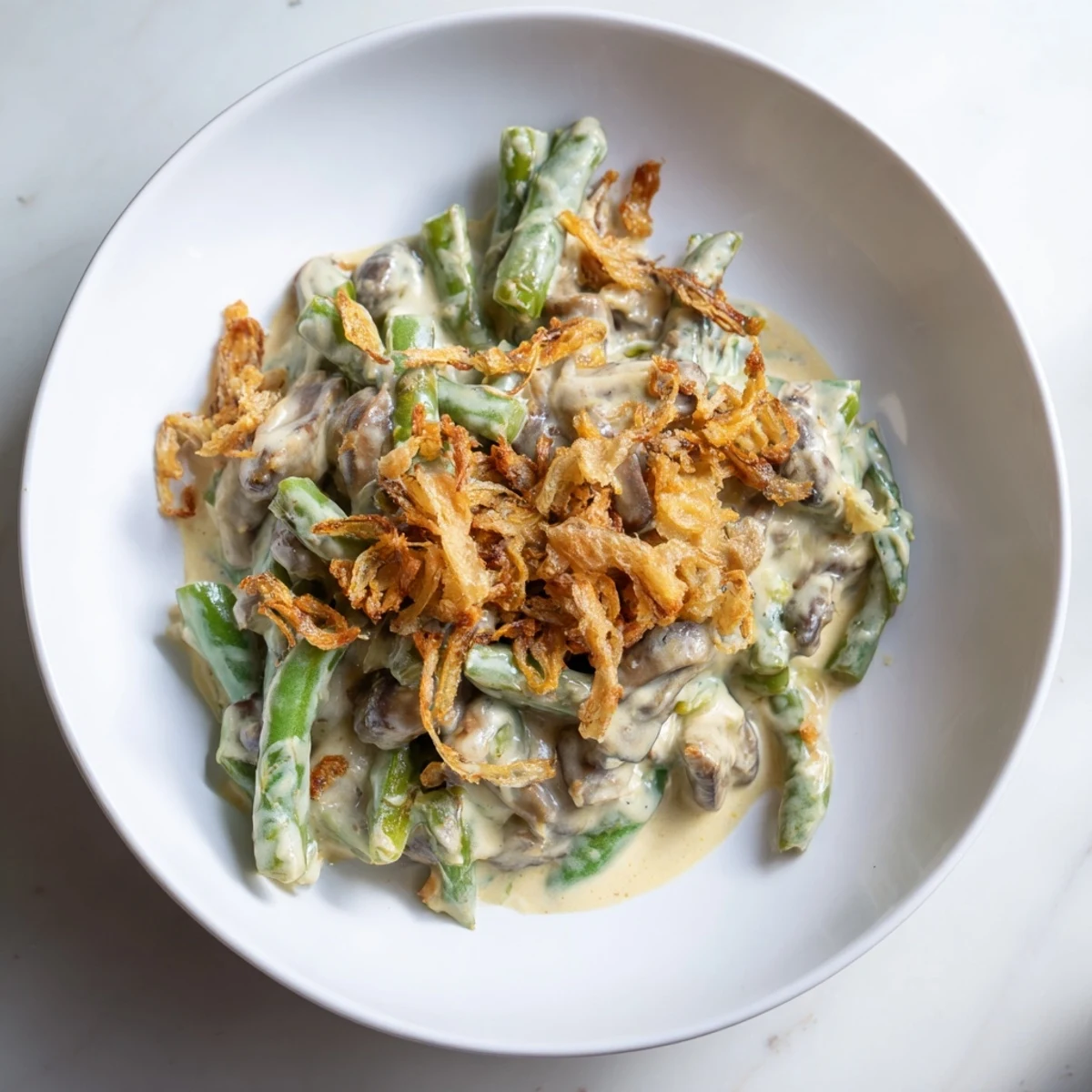 Creamy Old-School Green Bean Casserole with golden-brown crispy onions, perfect for a cozy Thanksgiving.