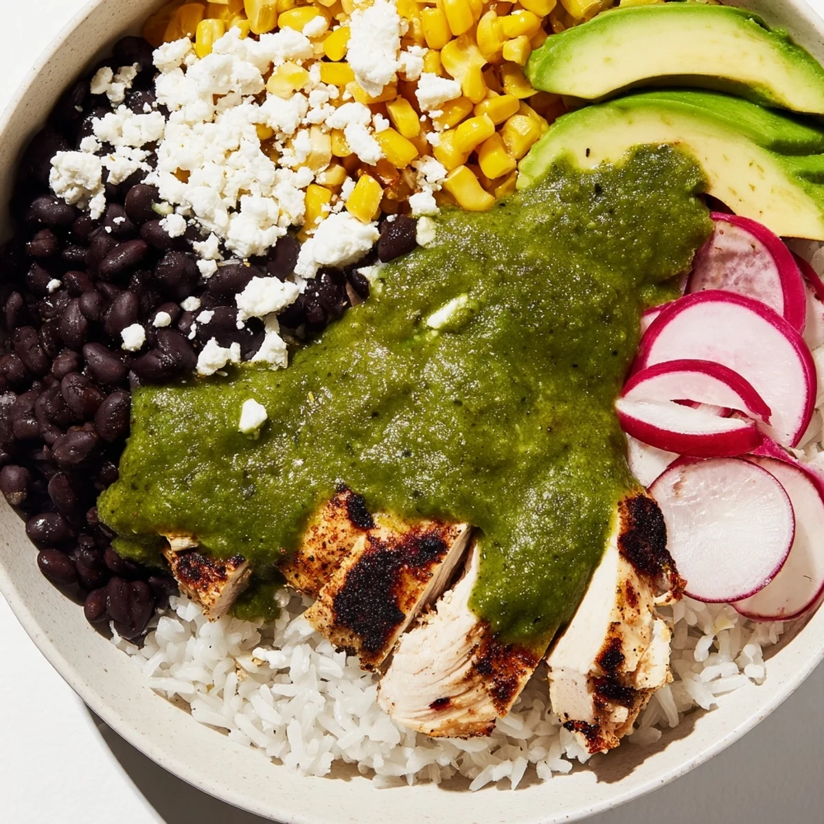 Green Enchiladas Rice Bowl: A colorful bowl with tender chicken, rice, and vibrant green enchilada sauce.