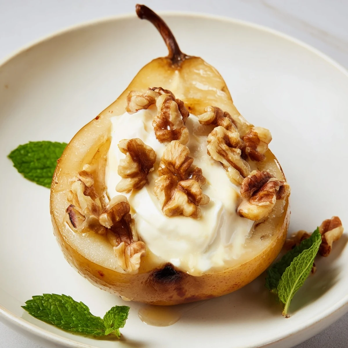 Warm, glistening roasted pears showcased with cinnamon spice, walnuts, and creamy Greek yogurt for serving.