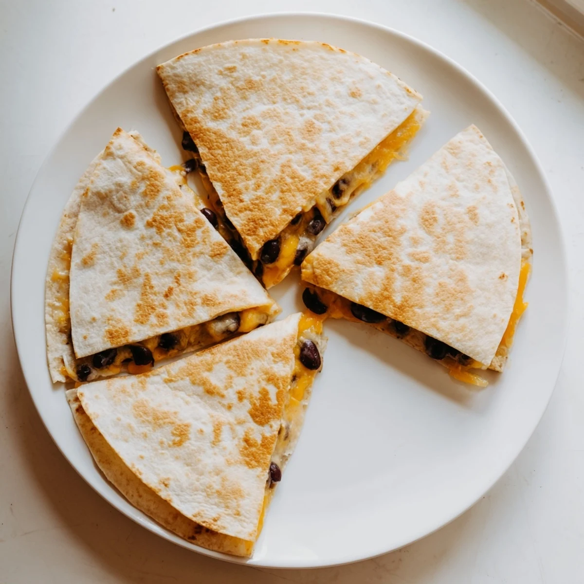 Warm and cheesy Bean & Cheese Quesadillas offer a satisfying bite, ready to serve with toppings.