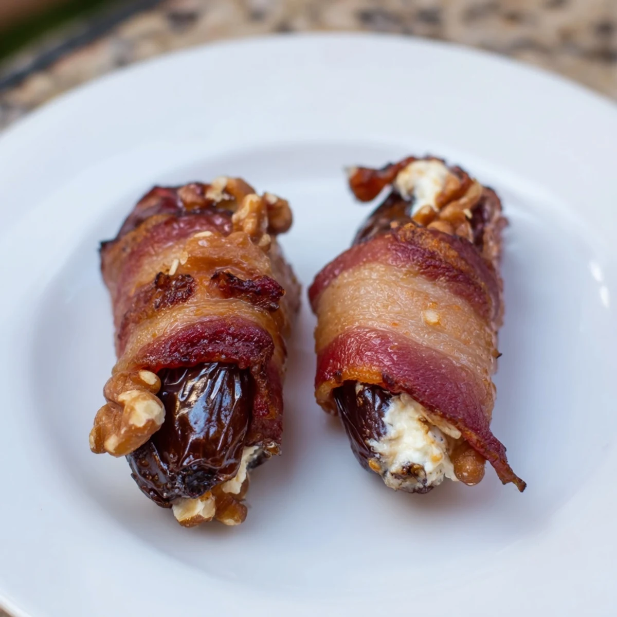 Crispy bacon-wrapped dates stuffed with creamy cheese and nuts, a satisfying appetizer.