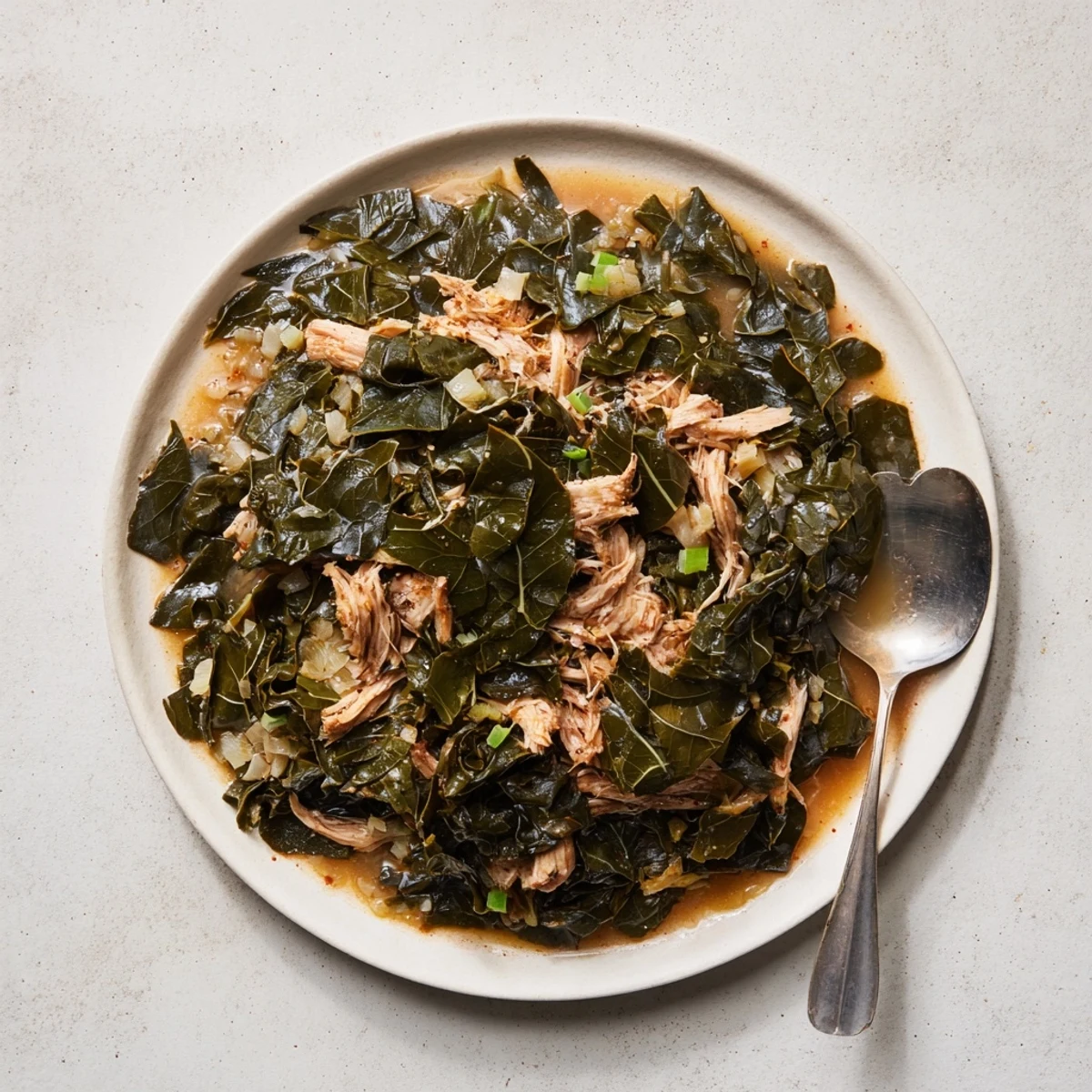 Savory Southern collard greens with smoked turkey, featuring tender leaves in a rich broth.