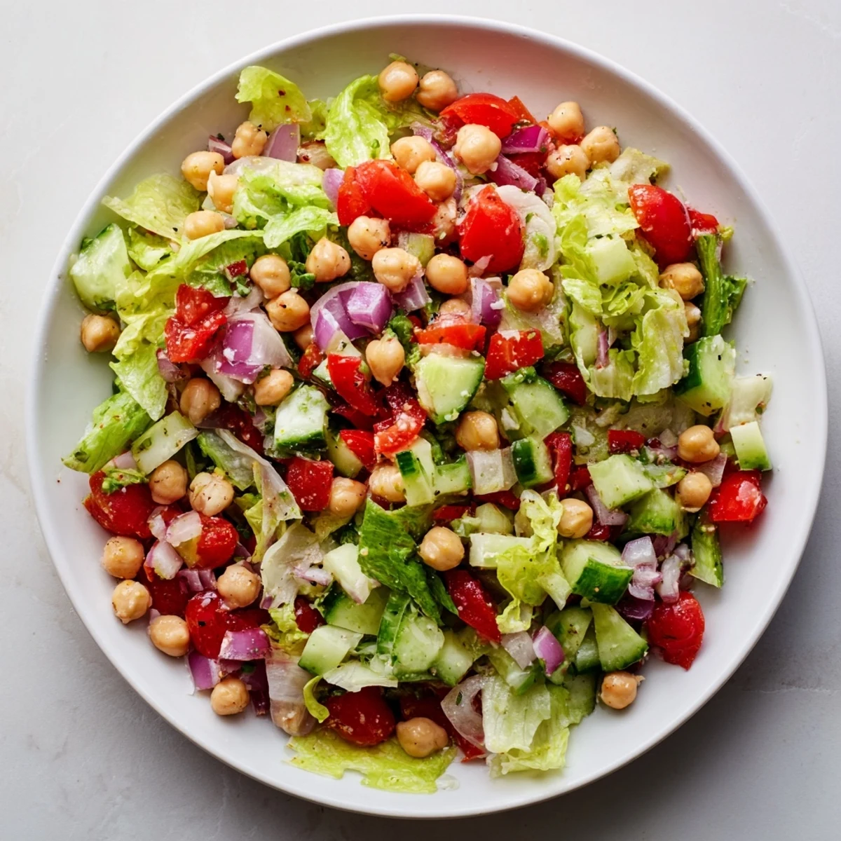 Fresh and colorful La Scala chopped chickpea salad, showcasing vibrant tomatoes and provolone cheese.