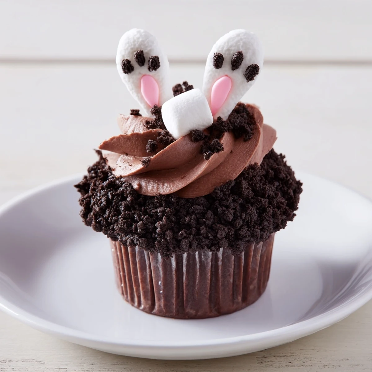 Adorable Bunny Burrow cupcakes showcase tender chocolate cake, covered in creamy chocolate buttercream.