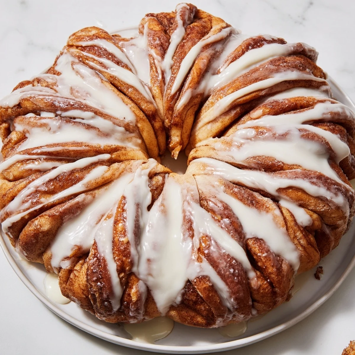A warm, golden Giant Snowflake Sweet Roll, glistening with icing, is the perfect holiday breakfast.