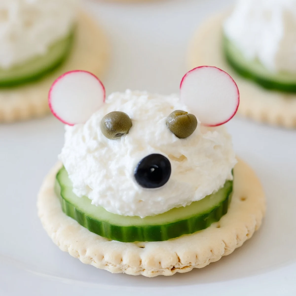 Creamy Polar Bear Iceberg Cracker Stacks sit ready to eat, featuring cucumber “ice” and olive noses.