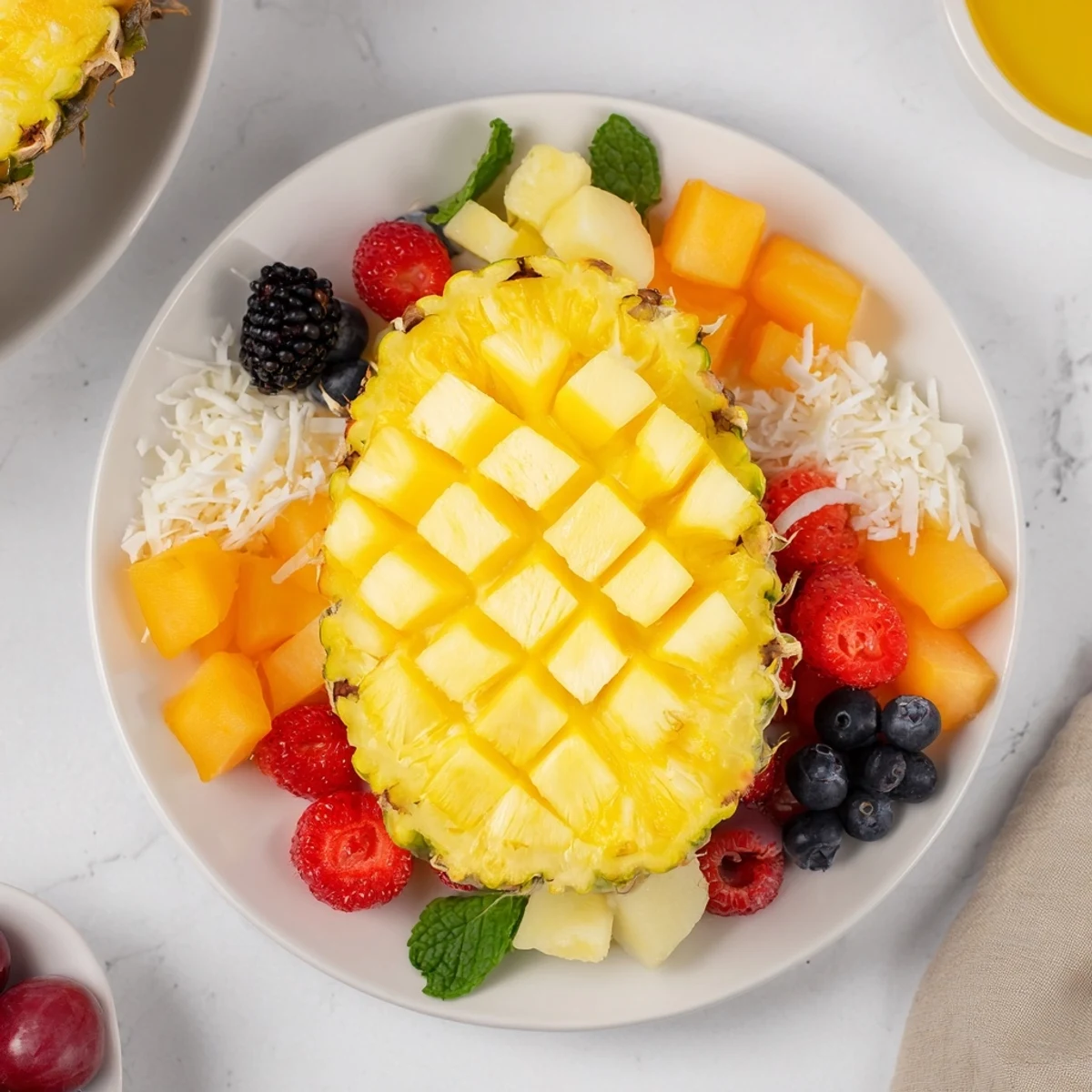 Fresh and vibrant tropical fruits artfully arranged around the Tropical Pineapple Paradise pineapple half.