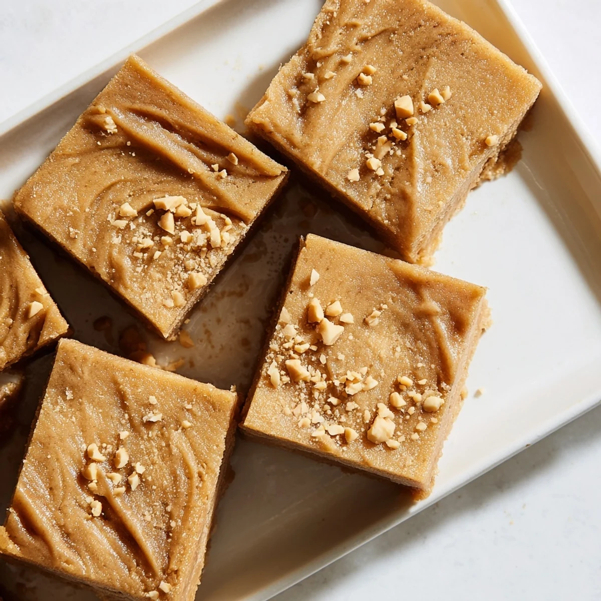 Golden-brown peanut butter mochi cake, a soft, chewy dessert with a rich peanut flavor, ready to serve.