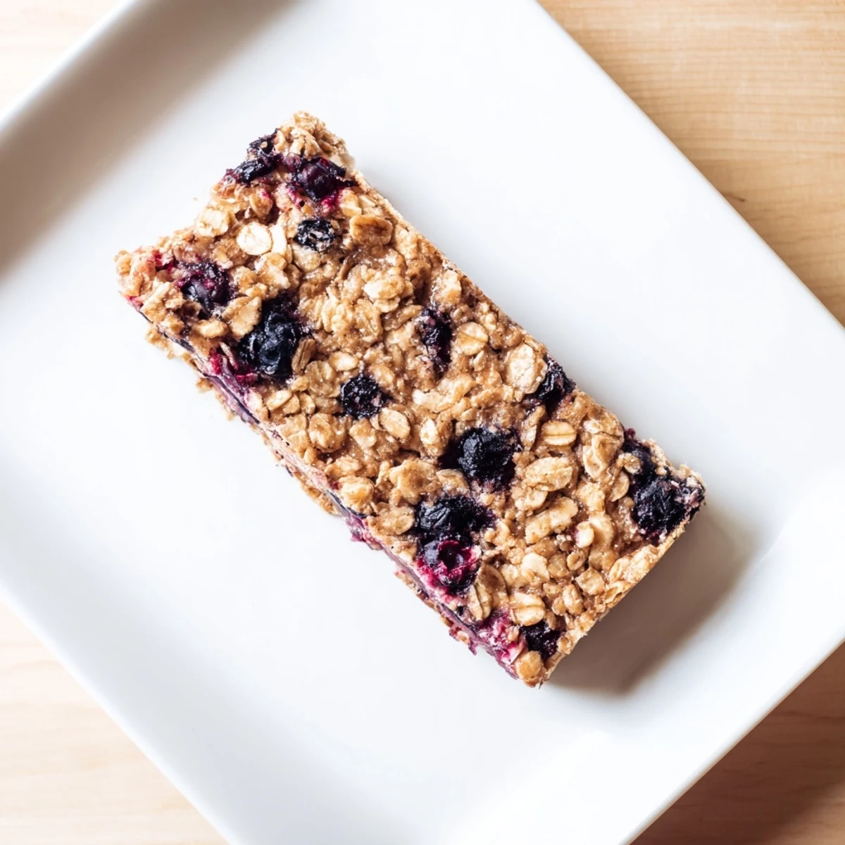 Golden-brown Blueberry Banana Oatmeal Protein Bars, studded with juicy blueberries, ready for a healthy breakfast.