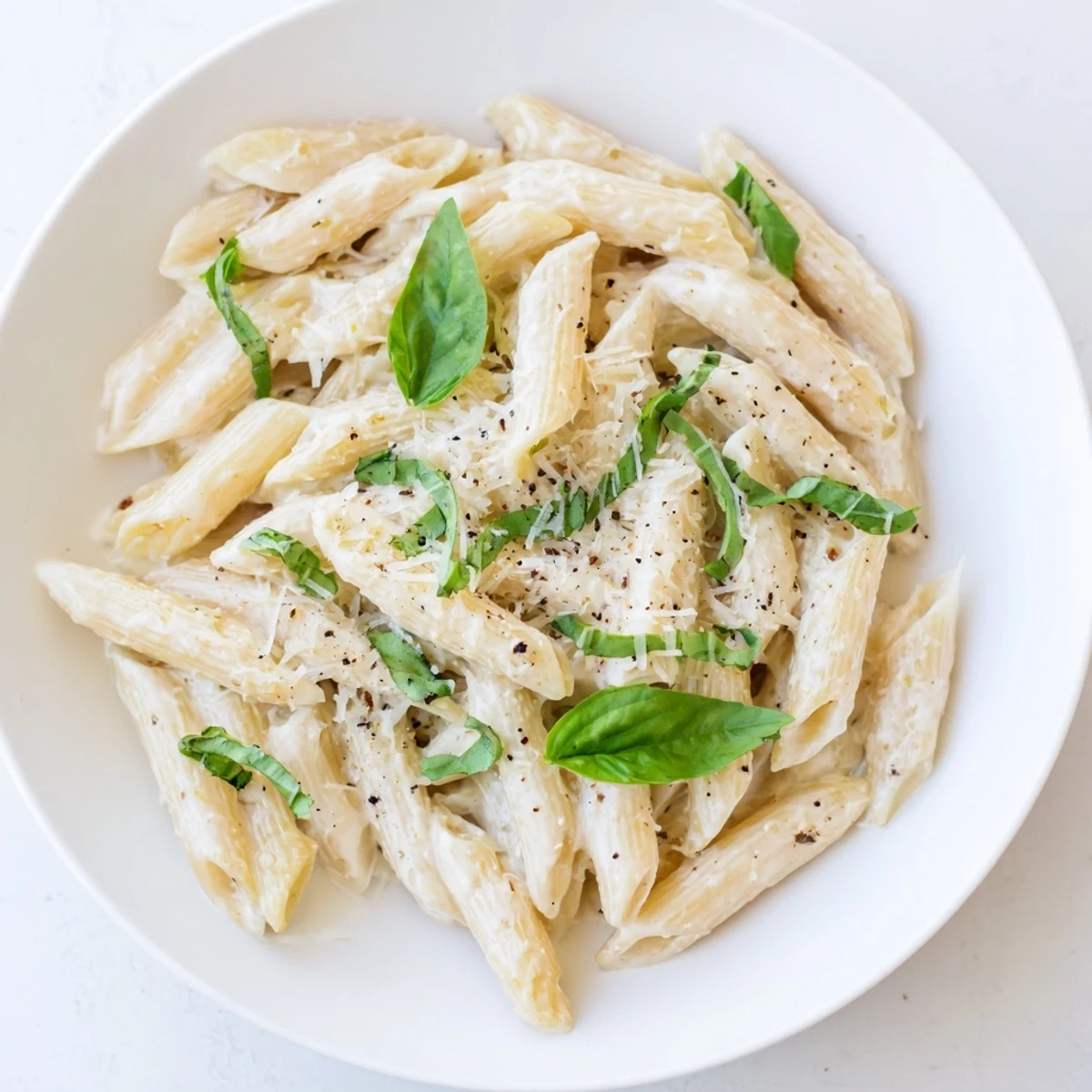 Silky, creamy cottage cheese pasta, perfectly coated with a fresh basil and Parmesan topping.