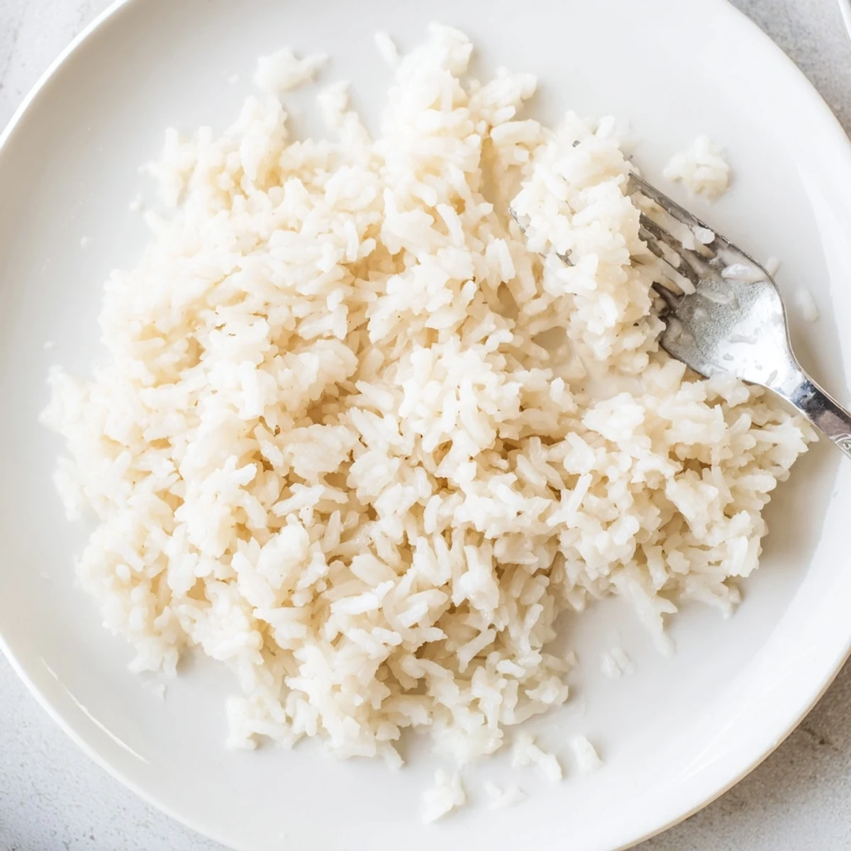 A close-up shot of fragrant Coconut Jasmine Rice, perfect beside a colorful spread of Thai curry.