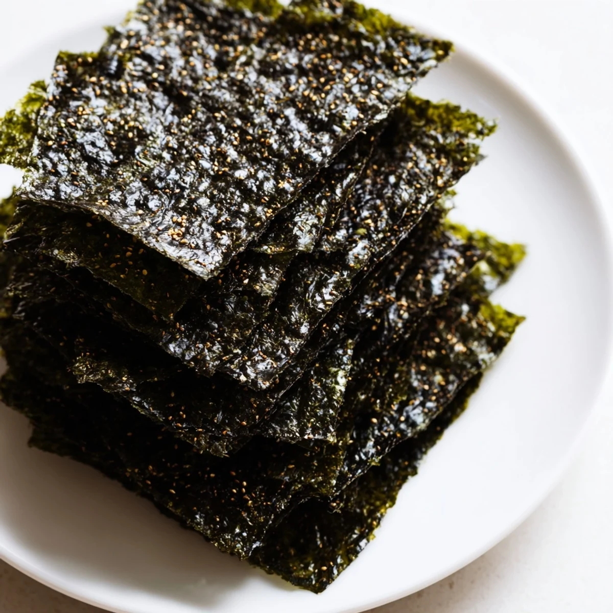 Crispy Roasted Seaweed Chips stacked on a plate, ready to snack.
