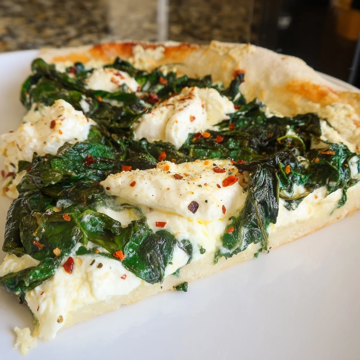 A delicious vegetarian spinach ricotta pizza, sliced and served with a crisp salad for a light meal.