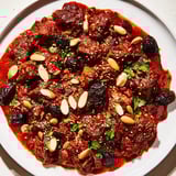 Golden almonds and sesame seeds crown the delicious Moroccan Lamb Tagine, a fragrant, hearty meal.