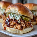 Tender shredded chicken simmered in smoky BBQ sauce, piled high on fluffy slider buns for easy handheld bites.  