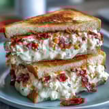 Southern-style pimento cheese finger sandwiches, neatly trimmed and arranged on a vintage serving tray for entertaining.