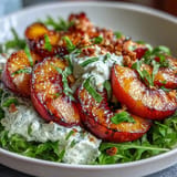 Close-up of a Grilled Peach and Burrata Salad with honey dressing, drizzled.