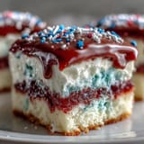 Festive Patriotic Poke Cake, glistening with white chocolate ganache, ready for celebration.