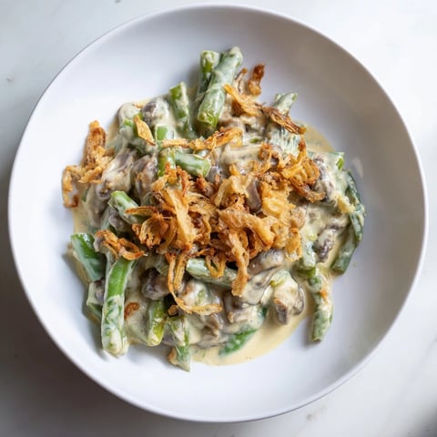 Creamy Old-School Green Bean Casserole with golden-brown crispy onions, perfect for a cozy Thanksgiving.
