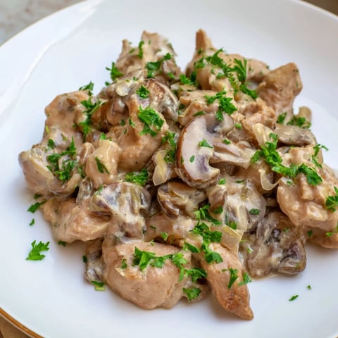 Golden-brown chicken pieces swimming in a creamy, savory sauce – a delicious Creamy Chicken Stroganoff.