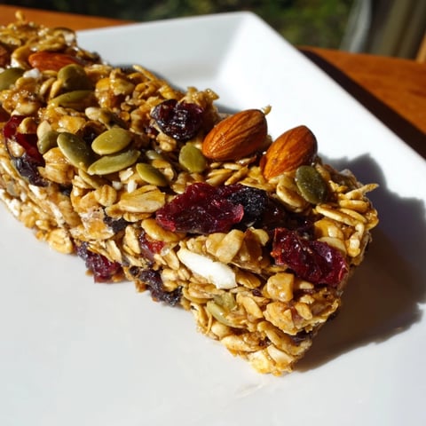 Golden-brown Roasted Pumpkin Seed & Cranberry Granola Bars, offering a satisfying crunch with every bite.