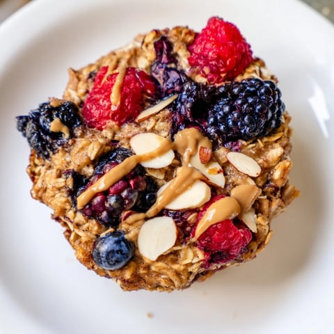 Warm, golden baked oatmeal cups with winter berries, a healthy breakfast made from scratch.
