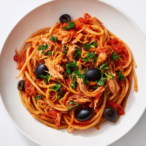 Pasta with Tuna Olives & Capers: A close-up of the flavorful pasta dish before serving, brimming with olives.