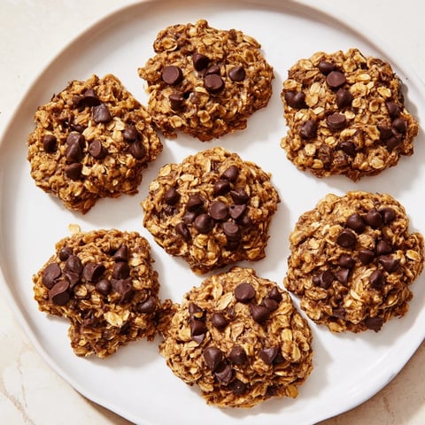 Warm, golden Oat-Banana Chocolate Chip Cookies, perfect for dessert with a glass of milk.