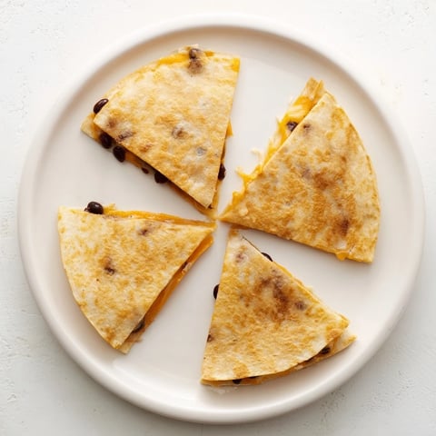 Golden, crisp Bean & Cheese Quesadillas are filled with melted cheese, served with fresh salsa.