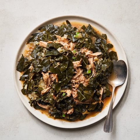 Savory Southern collard greens with smoked turkey, featuring tender leaves in a rich broth.