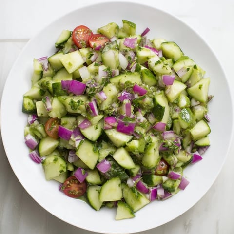 Fresh Simple Cucumber and Dill Chopped Salad, with vibrant greens and red onion, drizzled with flavorful dressing.