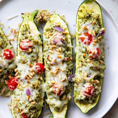 Golden, bubbly Cheesy Pesto Zucchini Boats, a vegetarian delight baked until tender and flavorful, ready to devour.
