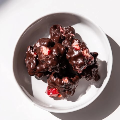 Chocolate-covered Strawberry Yogurt Clusters offer a refreshing, frozen, creamy treat with ripe strawberry pieces.