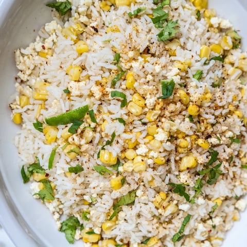 Fluffy Mexican Street Corn Rice, studded with charred corn and creamy cotija, ready for serving.