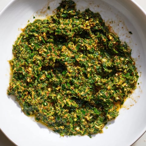 Vibrant close-up of Moroccan Chermoula Marinade, showcasing fresh herbs and bright citrus zest for fish.