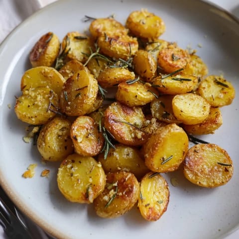 Savory rosemary garlic roasted potatoes served hot, perfect as a delightful side dish.  