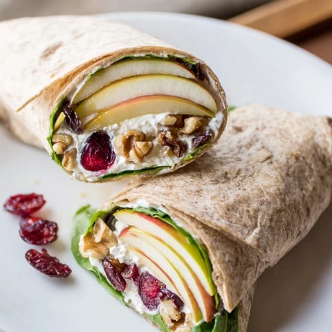 Creamy goat cheese and sweet cranberries inside the easy Cranberry Goat Cheese & Walnut Holiday Wrap for lunch.