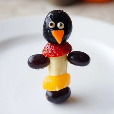 This colorful Penguin Fruit Skewer Army shows cute fruit penguins eagerly ready for a fun, healthy snack.