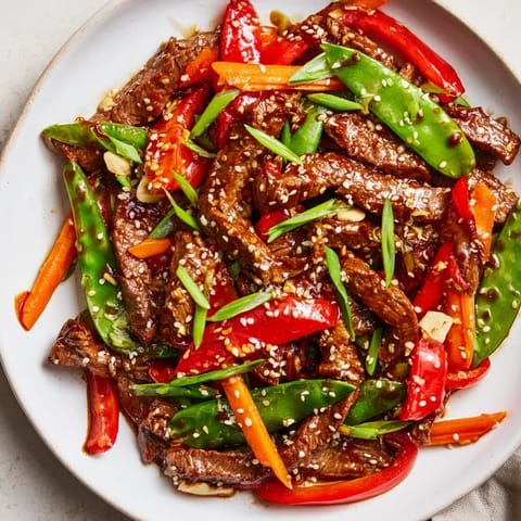 Flavorful Sweet Teriyaki Pork Stir-Fry, showcasing tender pork and colorful, crisp vegetables piled high.