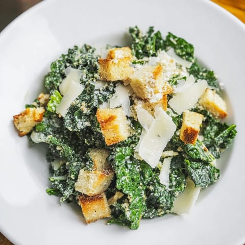 Fresh and vibrant Kale Caesar Salad with crispy croutons and shaved Parmesan.