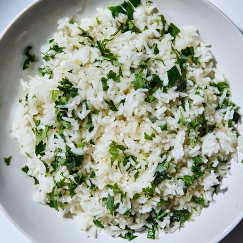 Fluffy cilantro lime rice, infused with fresh zest and herbs, steaming in a serving bowl.