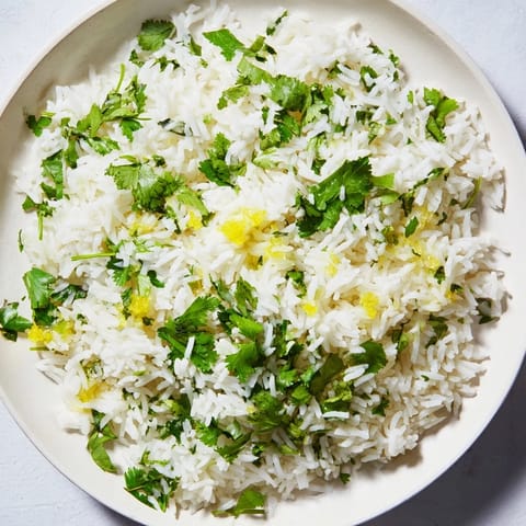 Bright green cilantro lime rice, a vibrant and flavorful side dish, ready to savor with your meal.