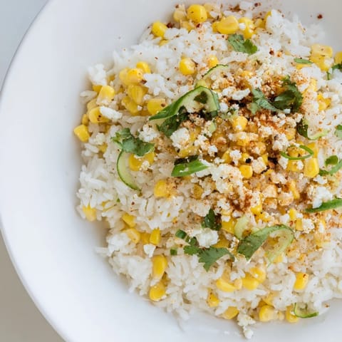 Vibrant image shows a colorful bowl of Mexican Street Corn Rice, a flavorful side dish.