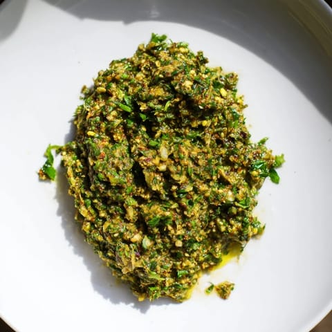 Aromatic, spicy Moroccan Chermoula Marinade ready to coat flaky fish fillets, perfect for grilling.