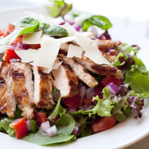 Savory Bruschetta Chicken Salad showcases juicy grilled chicken on mixed greens with a bright tomato-basil topping and Parmesan.