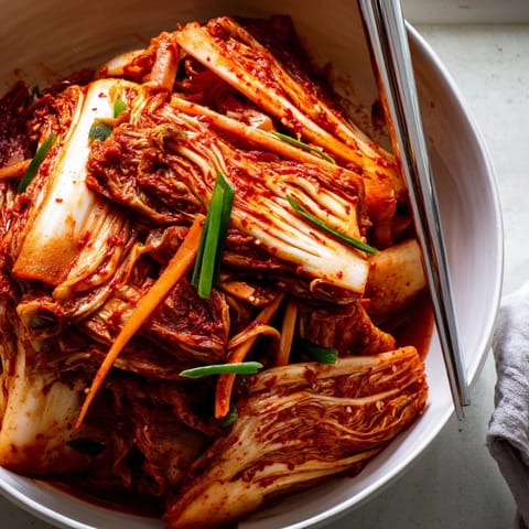 Vibrant, spicy homemade Kimchi bursting with fresh, tangy flavors ready to serve.